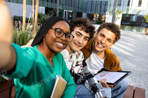 Preview: Multiracial college friends taking selfie with phone outside university building.Students having fun