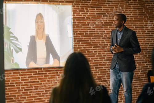 Preview: Serious African American male office manager in black blazer and