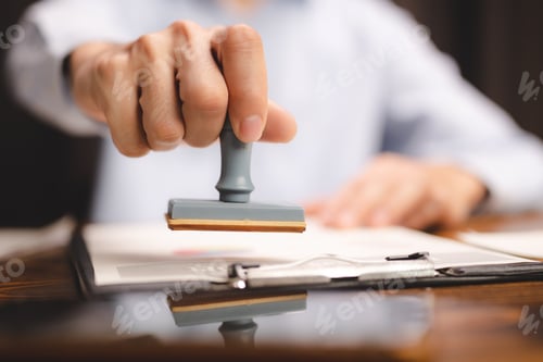 Preview: hand stamping with approved stamp on certificate document public paper at desk, notary or business