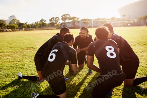 Preview: Cropped shot of a diverse group of sportsmen crouching together before playing rugby during the day