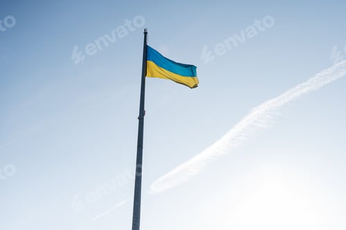 Preview: Large national flag of Ukraine flies in the blue sky. Big yellow blue Ukrainian state banner.