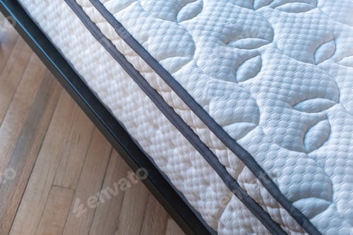 Preview: Mattress on a bed close up. Home bedroom interior detail, high angle view .