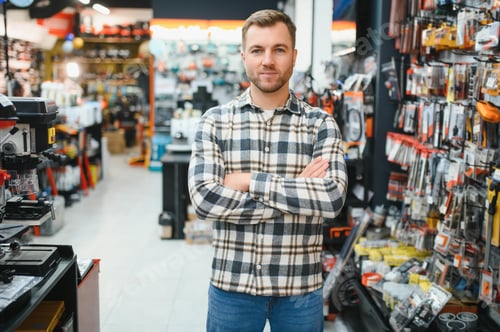 Preview: A man in a hardware store choosing a tool