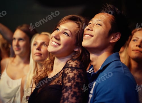Preview: They found each other through the crowd. A young couple kissing at a rock concert.