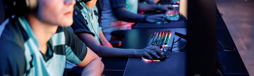 Preview: Young gamers playing online video game in computer club
