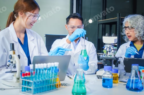 Preview: Two Asian men and women sit at a table in a laboratory, conducting research on liquids. They use