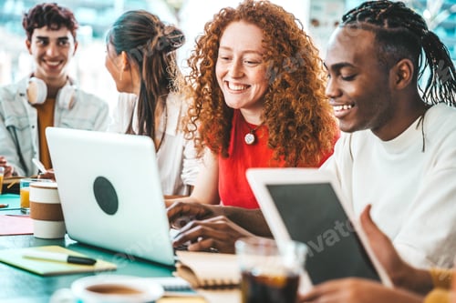 Preview: Multiracial university students sitting together at table with books and laptop
