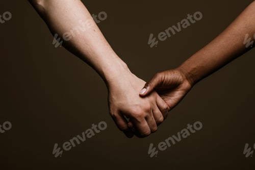 Preview: Black hand holding the white hand
