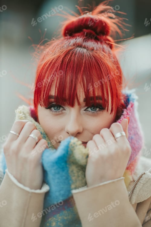 Preview: Portrait of a red-haired girl with bangs holding her colorful scarf
