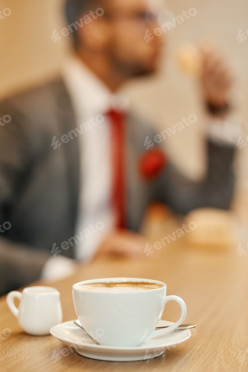 Preview: Selective focus of cup of coffee standing on the table