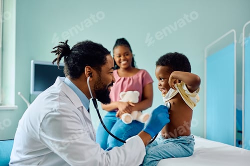 Preview: Happy black kid during medical examination at doctor's office.