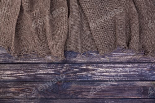 Preview: Burlap on dark wooden background, top view