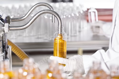 Preview: Research, development, production and manufacturing. Factory worker standing at filling line in mode