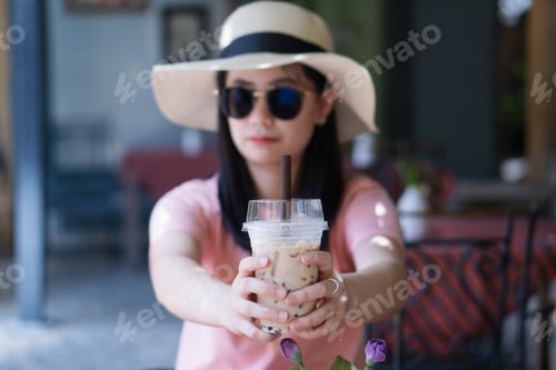 Preview: Woman Holding Iced Coffee Drink in Cafe Setting