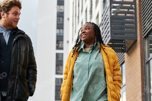 Preview: Caucasian Man and Black Woman Walking Together and Chatting