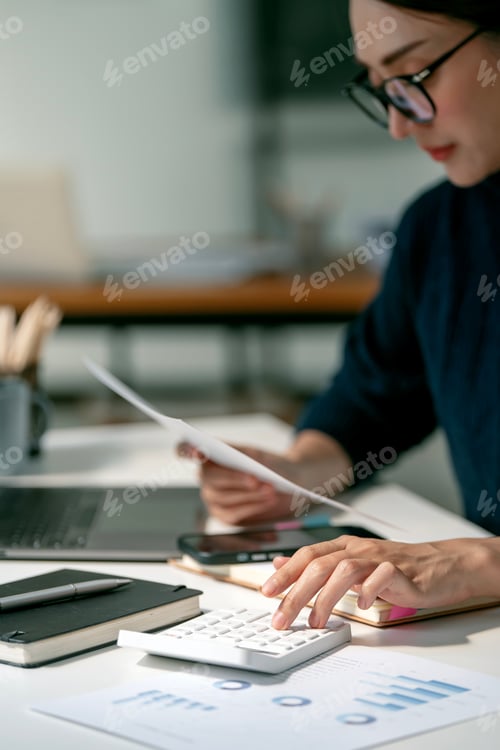 Preview: Asian female accountant or banker making calculations. Savings, finances and economy concept.
