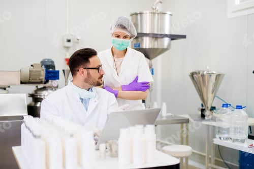 Preview: Two Laboratory Employees Discussing About Test Results.