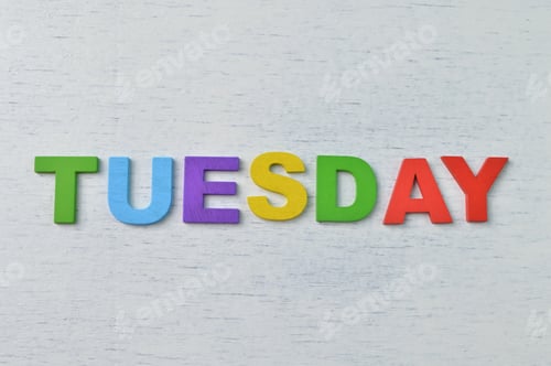Preview: Colorful wooden alphabet with text TUESDAY. A happy Tuesday concept.