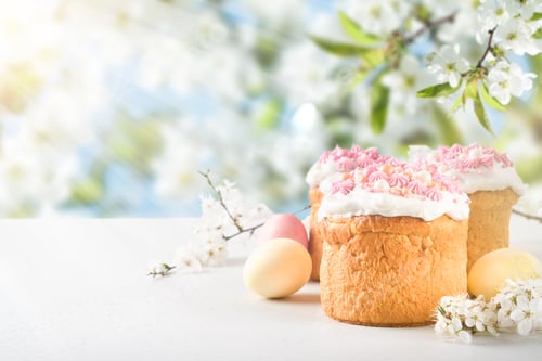 Preview: Traditional Easter cake with white swiss meringue and pink sweet decoration and colorful painted egg