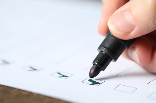 Preview: Woman checking box of paper form at table, closeup
