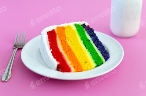 Preview: Colorful food, rainbow birthday cake on a plate with milk on a bright pink background.