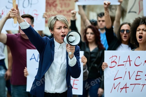 Preview: Caucasian woman leading anti-racism demonstrations and shouting through megaphone.