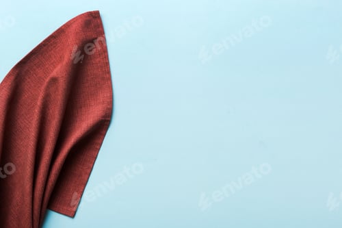 Preview: top view with red empty kitchen napkin isolated on table background. Folded cloth