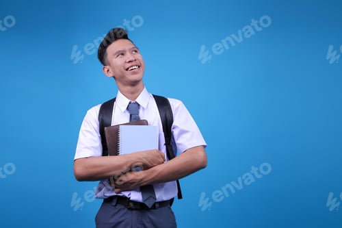 Preview: Positive Confidently Indonesian High School Student Guy Smiling And Looking To Side
