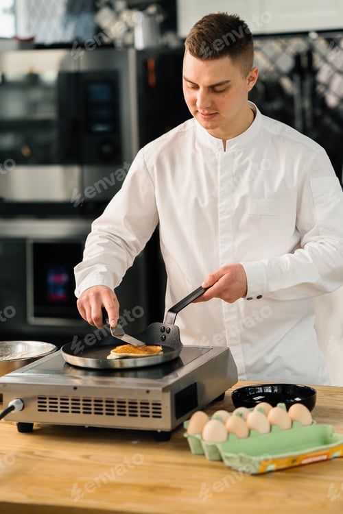 Preview: Professional kitchen chef prepares pancakes kitchen utensils