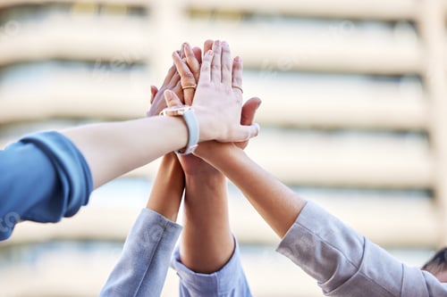 Preview: Community will take you far. Shot of a team of business people high fiving one another.