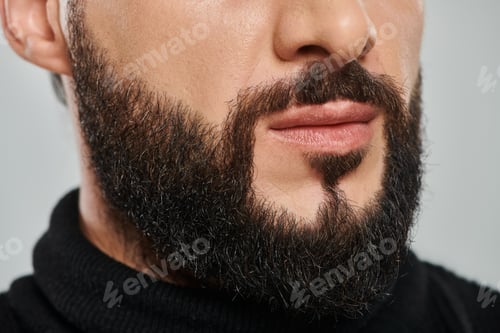 Preview: cropped shot of confident bearded arabic man in black turtleneck posing on grey background