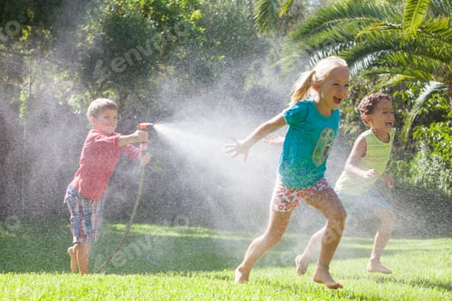 Preview: Three children in garden chasing each other with water sprinkler