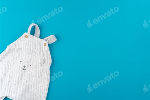 Preview: baby clothes on blue background top view