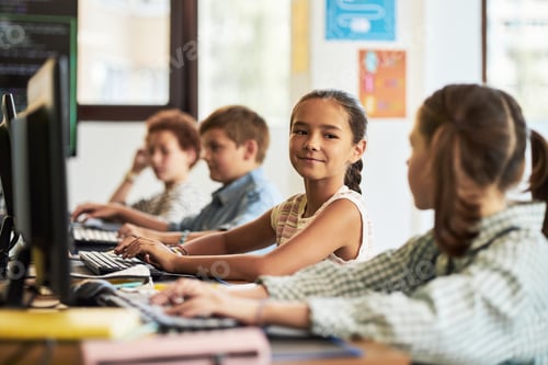 Preview: Preteen Girl Collaborating with Classmates Using Computers in Classroom