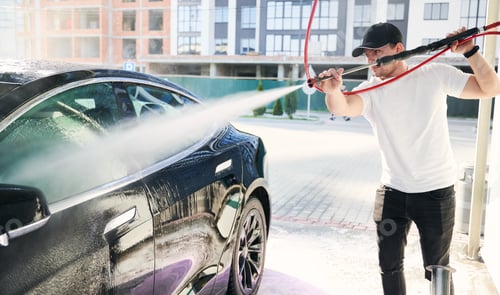 Preview: Boy cleaning auto by pressure water gun.
