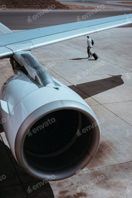 Preview: Airplane boarding. Turbine of engine airplane. Traveler with luggege in the background