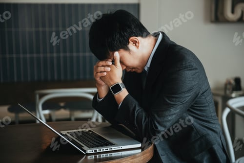 Preview: Businessman eyestrain fatigued from computer work.