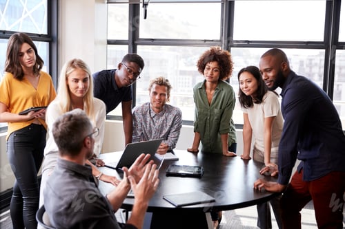 Preview: Creative business team listening to colleague at a brainstorm meeting