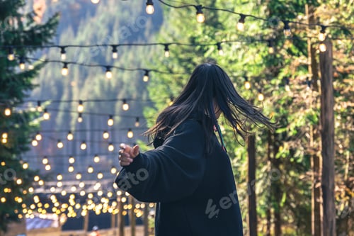 Preview: A young woman is dancing against the backdrop of mountains.