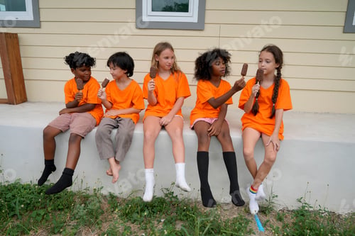 Preview: Children enjoying ice cream on a sunny day while wearing bright orange shirts