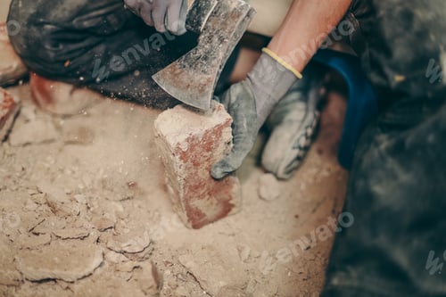 Preview: A young man cleans bricks with an axe.