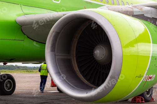 Preview: close-up of aircraft engine. green airplane turbine detail. Plane engine and technical staff