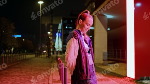 Preview: Girl standing night lights looking camera with smile. Woman enjoy evening time.