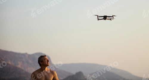 Preview: Caucasian man operating drone by remote control at sea shore