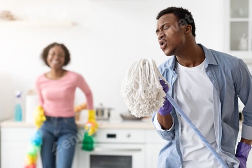 Preview: Funny black guy using mop as microphone, singing while cleaning