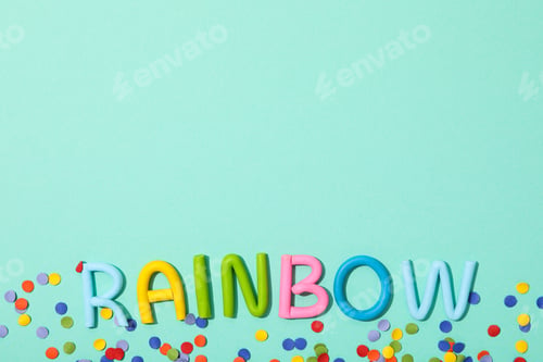 Preview: The word "rainbow" is made of colored plasticine on a turquoise background.