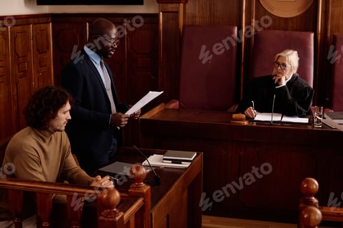 Preview: Young confident male attorney reading list of extenuating circumstances