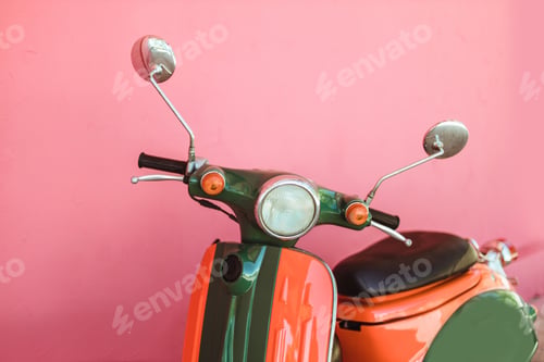 Preview: Colored scooter parked on the street on pink wall background. Rent and car sharing concept