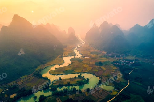 Preview: Golden sunrise over mountain range with winding river on agricultural village at Phong Nam Valley