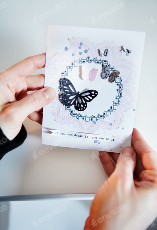 Preview: Admiring home handywork. Cropped shot of a womans hands holding a hand-made card.